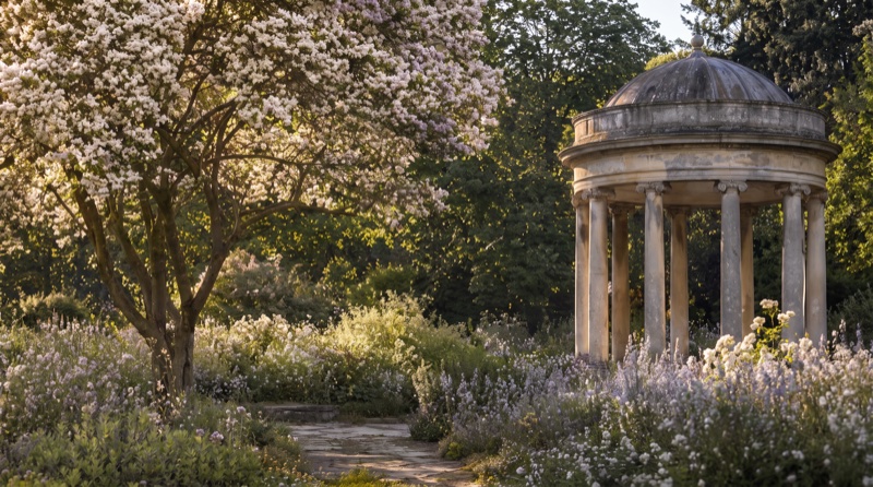 Location reference: a stone rotunda in a flowering garden at low sun